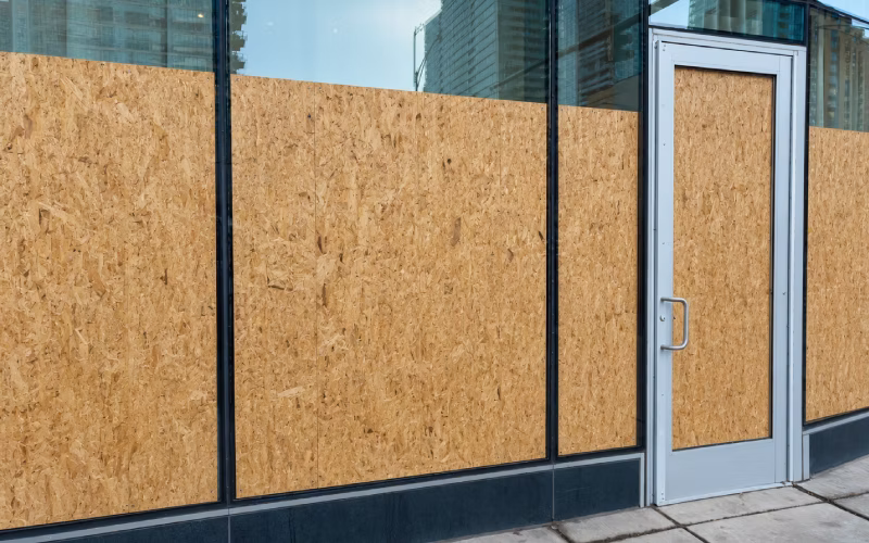 Boarding up a damaged window for temporary security