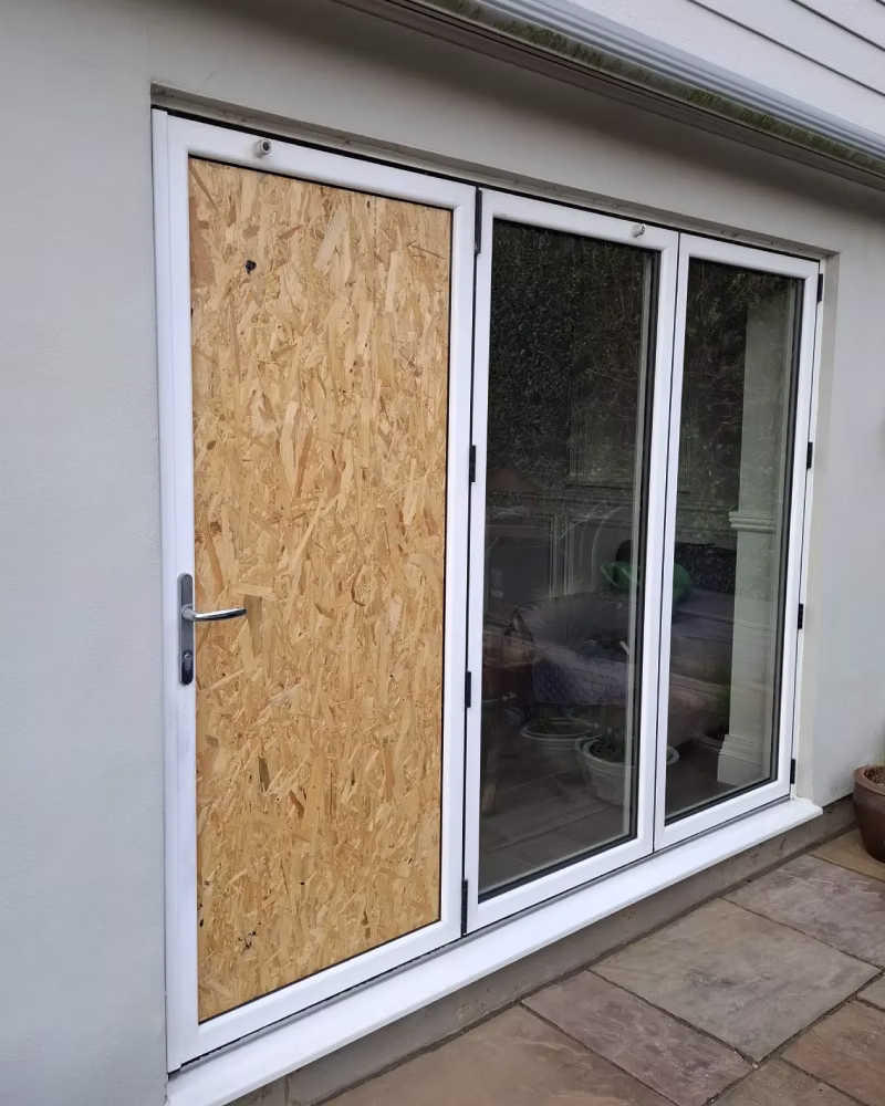 Boarded window securing a damaged property