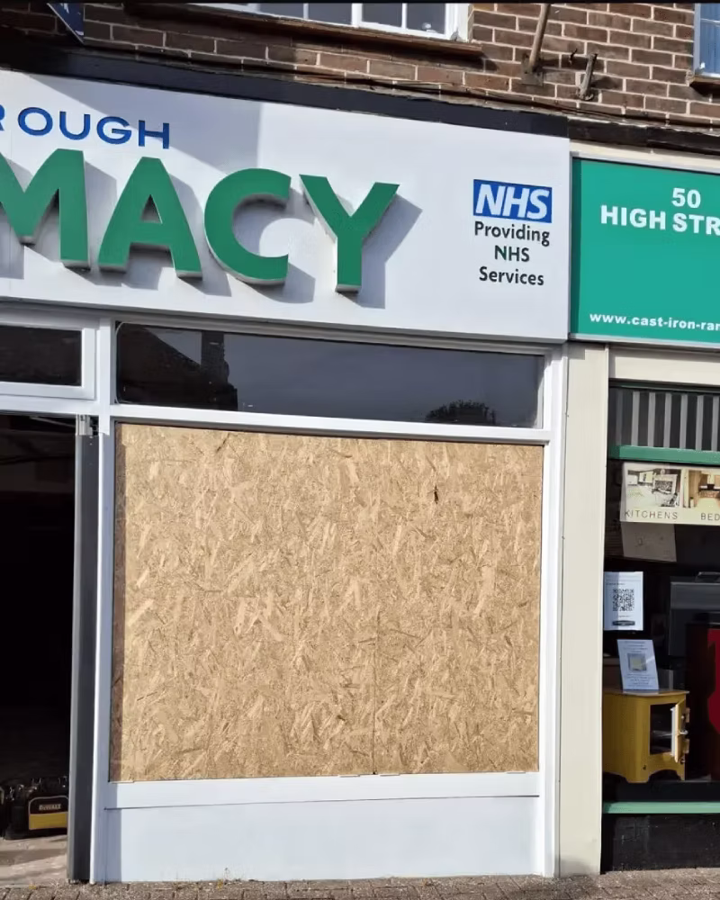 Emergency boarding up service securing a damaged window on a property.