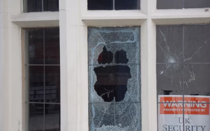 Broken window with shattered glass awaiting repair