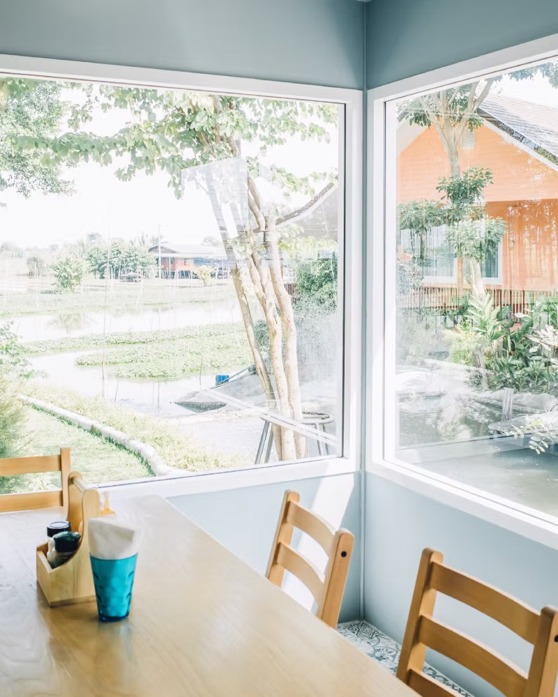 Emergency glazier replacing broken window glass after damage.